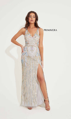 A woman models the Long Formal Dress 4299 by Primavera—a sleeveless, V-neck beaded gown with a thigh-high slit—standing against a plain white background. "PRIMAVERA" appears beside her.