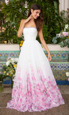 Ava Presley 43001 strapless white floor-length gown featuring a pleated bodice, embellished neckline, and a pink floral print on the A-line skirt.