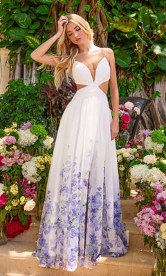 A woman stands among flowers wearing a white, light blue, and multi-colored Ava Presley 43003 floral prom dress with a plunging neckline, waist cutouts, and a floor-length floral hem.