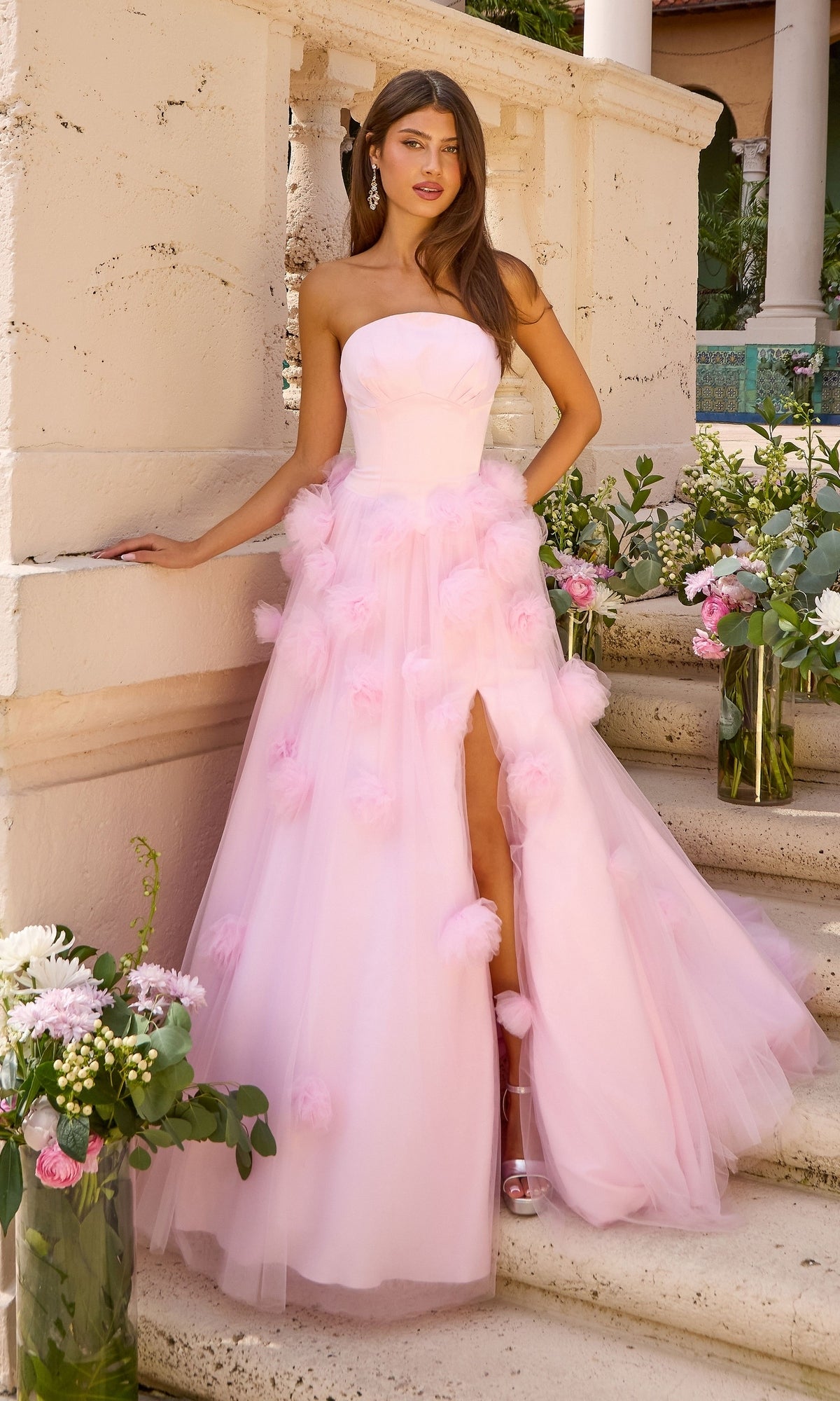 Ice pink strapless Ava Presley 43019 ball gown featuring a high leg slit and 3D floral embellishments on the skirt.