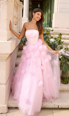 A person wears an Ava Presley 43019 strapless pink floor-length gown with a tulle skirt and 3D floral accents.