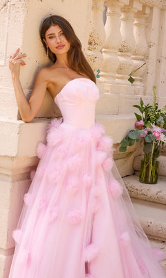 A woman wears an Ava Presley 43019 strapless, light pink, floor-length ball gown featuring a tulle skirt embellished with 3D floral clusters.