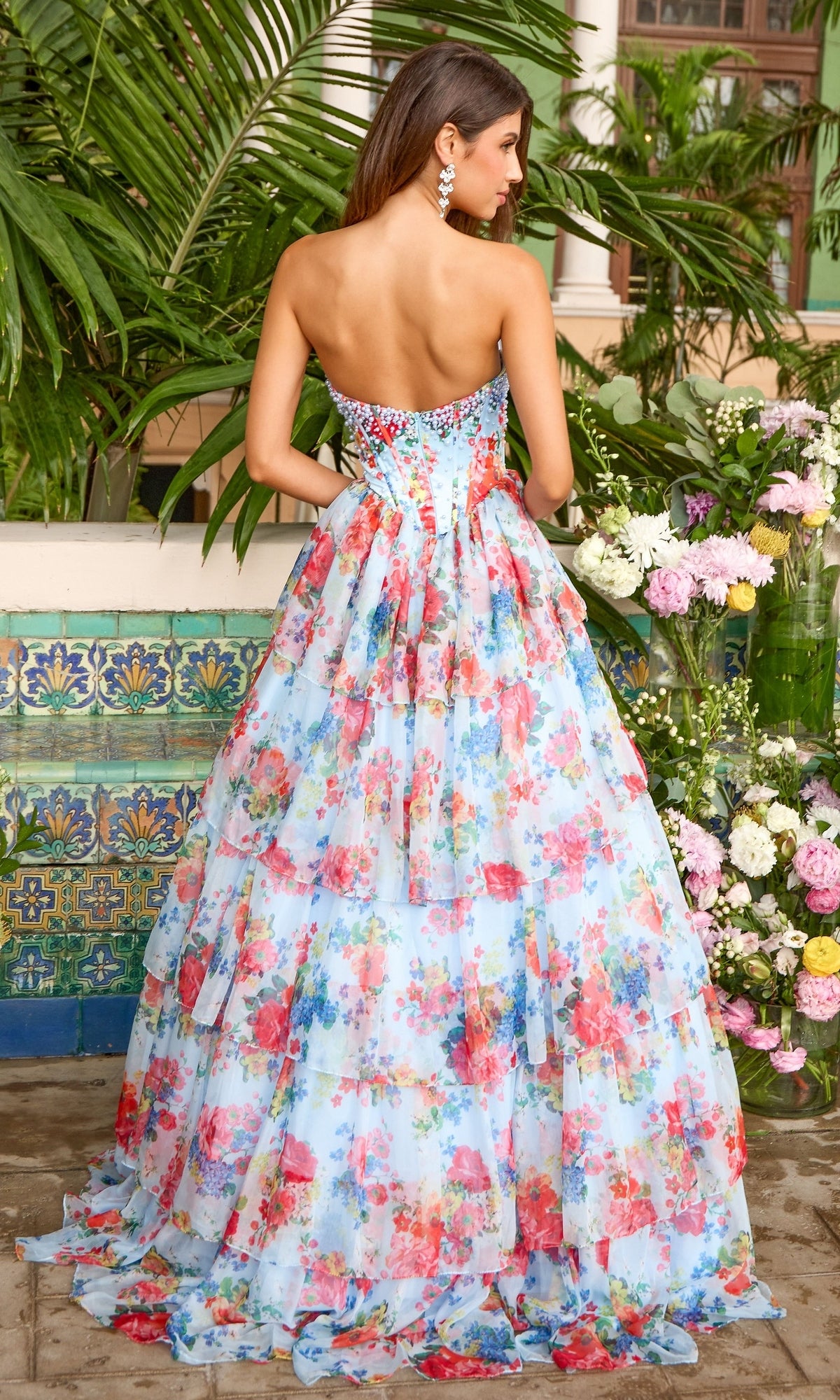 Ava Presley 43036 floor-length strapless gown featuring a sweetheart neckline, crystal-embellished corset bodice, and a tiered, multi-colored floral print skirt.