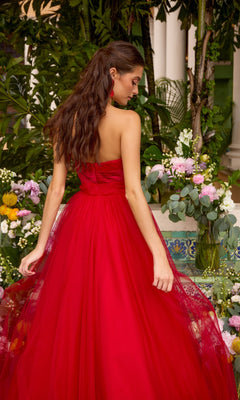 A person seen from behind wears a red, strapless, floor-length Ava Presley 43045 prom dress with a voluminous tulle skirt.