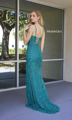 A woman in the Lace-Up Long Sequin Prom Dress: Primavera 4306 stands on a patio, showcasing the gown’s delicate back detail as she looks over her shoulder.