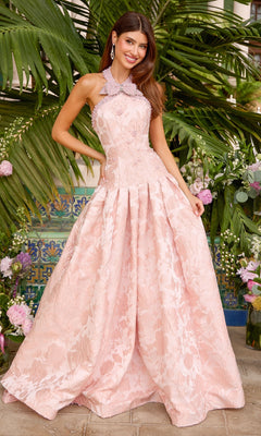 A woman wears a blush, sleeveless Ava Presley 43084 ball gown with a vintage-inspired pearl bow collar, a high embellished neckline, and a jacquard floral pattern.