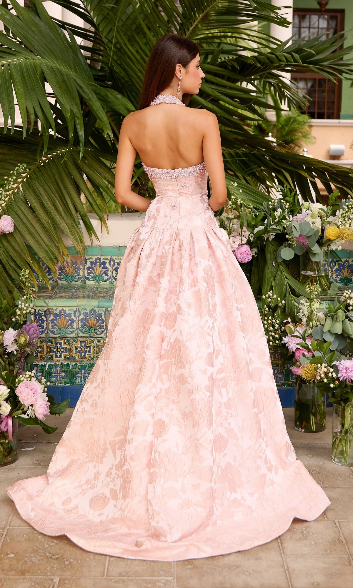 Back view of the Long Prom Dress: Ava Presley 43084, a light pink, strapless, floor-length gown with a vintage-inspired floral pattern and a beaded neckline.