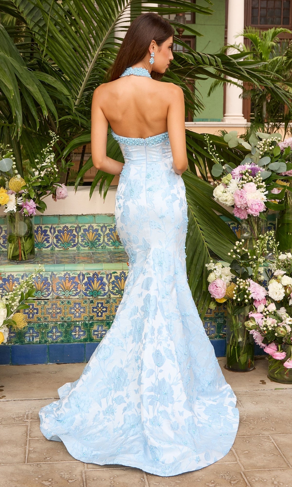 Back view of the Long Prom Dress: Ava Presley 43085, a light blue, floor-length mermaid gown with floral lace appliqué and a beaded, strapless neckline.