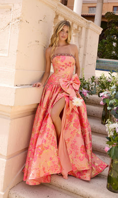 Ava Presley 43103 strapless coral pink floral prom dress with a beaded neckline, a large bow at the waist, and a high leg slit.