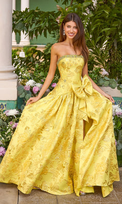 Long Prom Dress: Ava Presley 43103, a strapless yellow floor-length gown featuring a floral pattern, a beaded neckline, and a large side bow at the waist.
