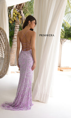 A woman in the Long Prom Dress: Primavera 4312—lavender, sequin, with a square neckline and lace-up open back—stands indoors near white curtains and tropical plants. "PRIMAVERA" is displayed beside her.