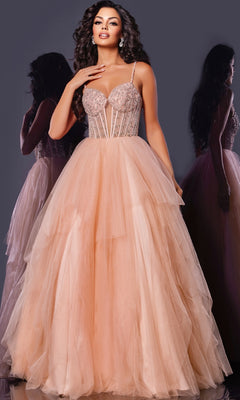 A woman models the Jovani 43254 long prom dress in blush pink, featuring an embellished corset bodice and voluminous tulle skirt, standing against a dark background with her reflection visible.