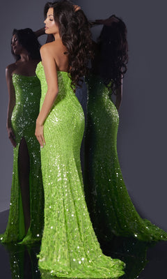A woman models the Long Prom Dress: Jovani 43338—an elegant, bright green, strapless sequin gown with a high slit—posing before a mirror to showcase both its back and side views.