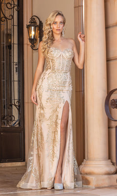 A woman stands before a stone building wearing the Strapless Corset Glitter Long Prom Dress 4335, featuring a corset bodice, embellished details, thigh-high slit, and paired with silver high heels.