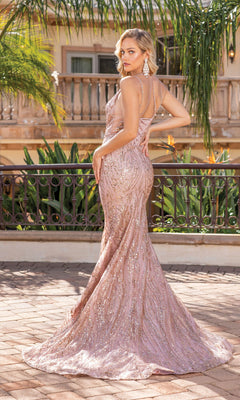 A woman poses outdoors in the Long Glitter Mermaid Formal Prom Dress 4337, a fitted blush pink gown with thin straps and sparkling sequins, elegantly turning her back for the camera.