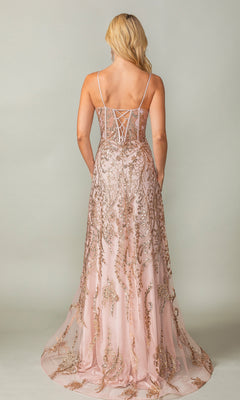A woman stands facing away, wearing the Dancing Queen 4359 glitter-print long prom dress in pink, featuring thin straps, gold embroidery, and a lace-up back.