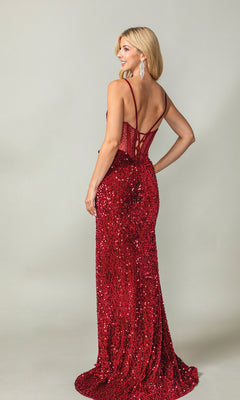 A woman poses and smiles in the Lace-Up Long Sequin Prom Dress: Dancing Queen 4360—a red, floor-length, sequin gown with thin straps and an open back—against a plain light gray background.