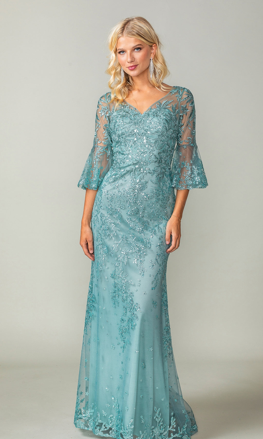 A woman in the Dancing Queen 4361 Bell-Sleeve Long Prom Dress, a light blue floor-length gown with lace and sheer three-quarter bell sleeves, stands against a plain background.