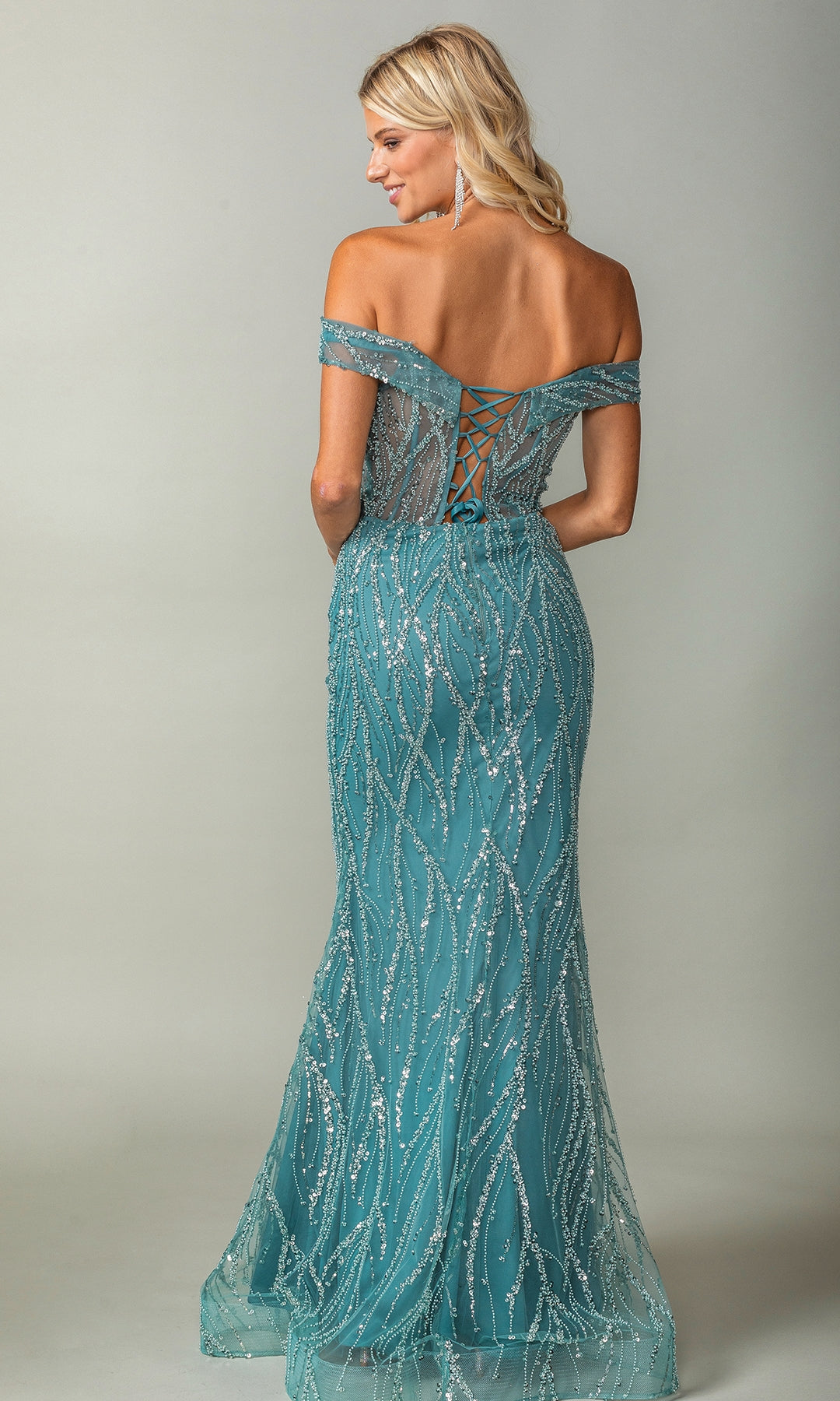 Woman wearing the Glitter-Print Long Prom Dress: Dancing Queen 4370—a teal, off-the-shoulder evening gown with sequin detailing and lace-up back—stands facing away from the camera.