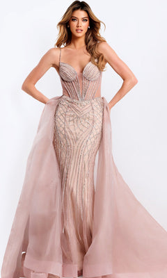 A woman models the Long Prom Dress: Jovani 43854 in rose/champagne, featuring a beaded fitted silhouette with a corset bodice, sheer panels, silver accents, and a detachable tulle overskirt against a plain white background.