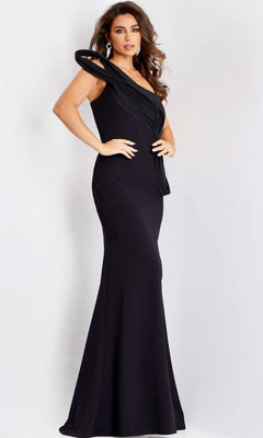 A woman models the Jovani 43970 long prom dress—fitted, floor-length, black, with a sculpted asymmetrical one-shoulder neckline—paired with statement earrings against a plain light background.