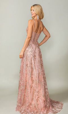 A woman wears the Long Glitter-Print Prom Dress: Dancing Queen 4402, a blush pink floor-length gown with sequins, spaghetti straps, and a sheer embellished lace-up back, as she stands facing away.