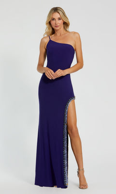 A woman poses against a plain background wearing the Bead-Trim Long Indigo Prom Dress by Mac Duggal 44030, featuring a fitted one-shoulder design, embellished trim, high side slit, and strappy high heels.