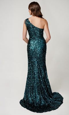A woman stands with her back to the camera, wearing the floor-length Sequin Prom Dress: Nina Canacci 4405, featuring a one-shoulder neckline, set against a plain background.