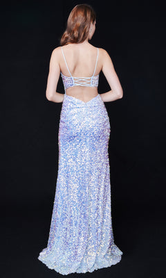 A woman faces away in the Nina Canacci 4406, a long sequin formal dress with thin straps, open back, and high side slit, set against a plain black background.