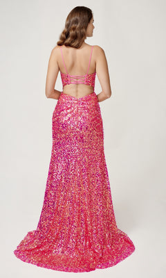 A woman wears the Nina Canacci 4406 long sequin formal dress with spaghetti straps, corset bodice, open back, and side leg slit. The floor-length pink gown sparkles against a plain white background.