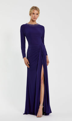 A woman in the Mac Duggal 44069 Bead-Neckline Long Formal Dress—a floor-length purple gown with long sleeves, a thigh-high slit, and pearl-embellished neckline—wears silver open-toe heels and stands against a plain white background.