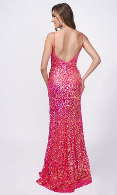 Woman facing away in a shimmering Nina Canacci 4410 long formal dress featuring thin straps, a low back, and a subtle thigh-high slit, set against a plain light background.