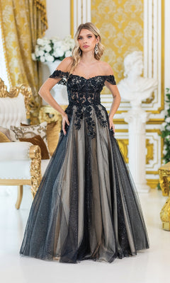 A woman in the Off-Shoulder Prom Ball Gown: Dancing Queen 4429, featuring an embroidered lace corset and flowing A-line skirt, stands in a lavish room with gold accents, ornate furnishings, and classic decor.