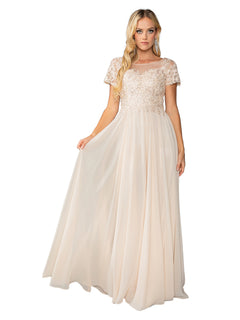 A woman in the Dancing Queen 4433 short sleeve long prom dress, featuring a light beige beaded skirt and lace bodice, stands against a white background.