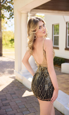 A woman with blonde hair stands outdoors on a paved walkway, looking over her shoulder and wearing the Primavera 4434 short homecoming dress in gold and black sequined embroidery with a fitted silhouette.