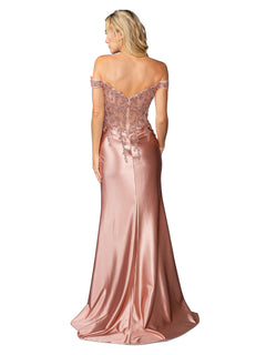 A woman wears the Dancing Queen 4442, a floor-length prom dress with a lace bodice and off-the-shoulder rose gold satin design, seen from the back.