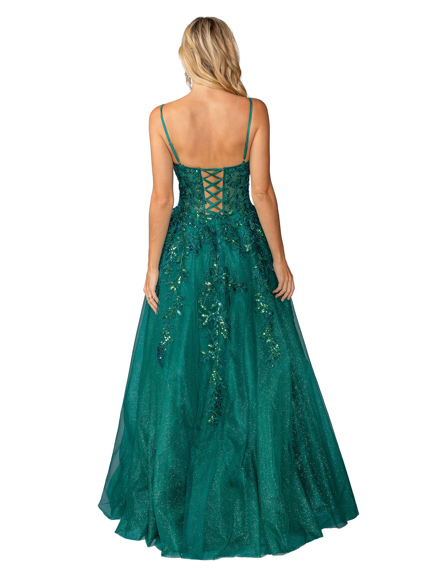 A woman with long blonde hair is seen from behind wearing the Dancing Queen 4452: a green, floor-length glitter prom ball gown featuring an A-line silhouette, lace-up open back, and floral embellishments.