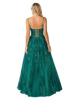 A woman with long blonde hair is seen from behind wearing the Dancing Queen 4452: a green, floor-length glitter prom ball gown featuring an A-line silhouette, lace-up open back, and floral embellishments.