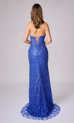 A woman faces away in the Long Sequin Prom Dress Nina Canacci 4458, a strapless royal blue gown with sequins, lace-up back, sheer corset bodice, floor-length silhouette, and a slight train for elegance.