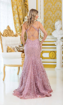 A woman stands in an ornate room wearing the Strappy Long Beaded Prom Dress: Dancing Queen 4464, a floor-length lavender gown with sparkling beads and a crisscross strappy back design.