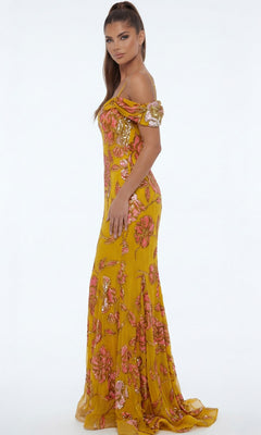 A woman stands sideways against a plain white background, wearing the Long Formal Dress: Jovani 44652 in yellow with pink floral sequins.