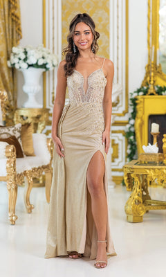 A woman wears the Dancing Queen 4495, a gold, floor-length prom gown with an embellished bodice and thigh-high slit, standing in an ornate room decorated in gold and white with floral arrangements.