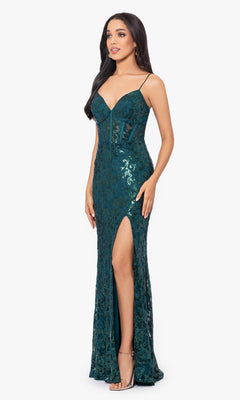 A woman models the Sequin-Lace Long Lace-Up Prom Dress 4521BN, featuring teal sequin-lace, spaghetti straps, a deep neckline, sheer corset bodice, and high side slit—an affordable statement piece against a plain white background.