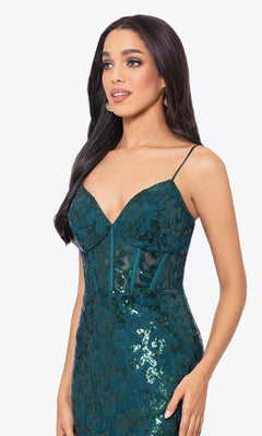 A woman poses against a plain white background wearing the Sequin-Lace Long Lace-Up Prom Dress 4521BN, featuring spaghetti straps and a sheer corset bodice at an affordable price.