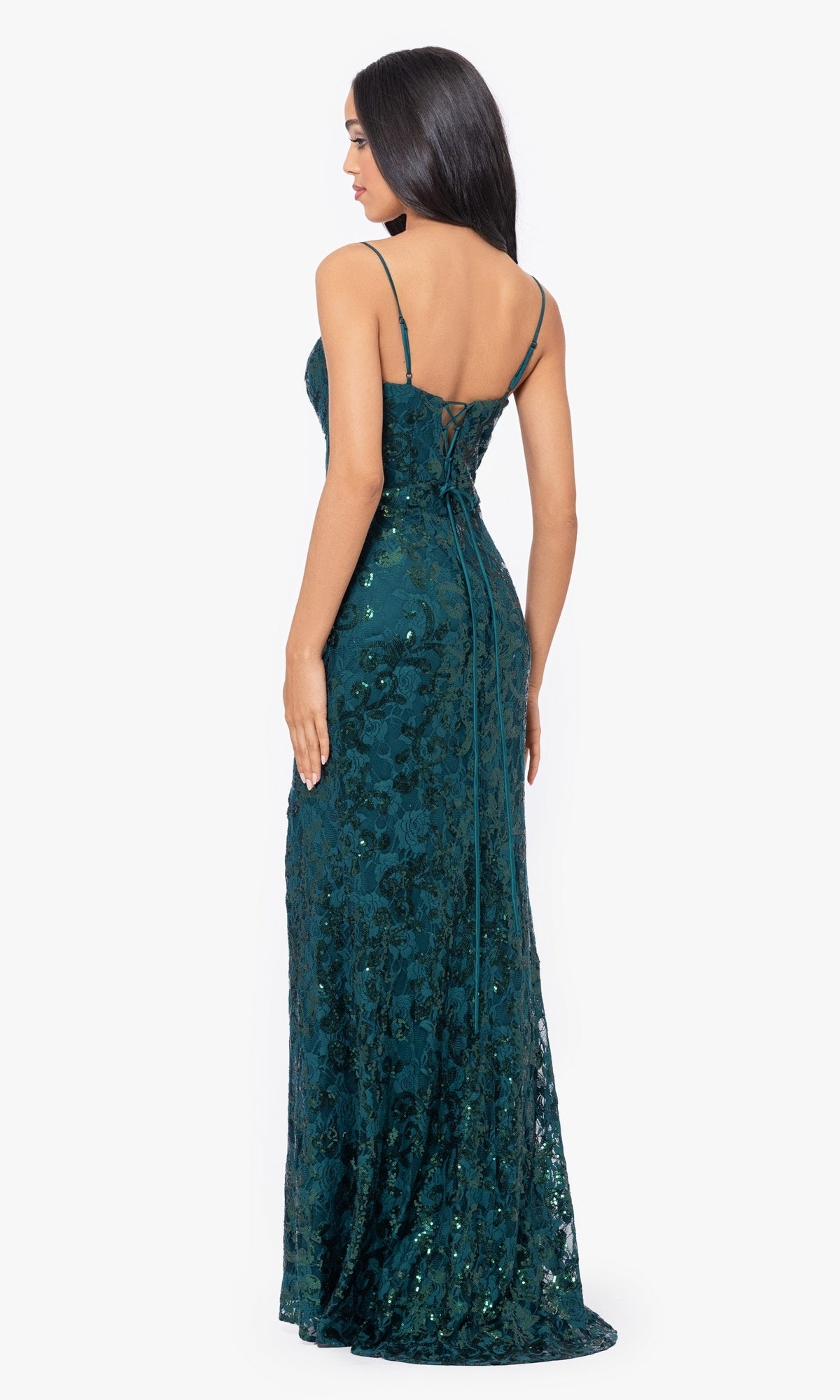 A woman models the Sequin-Lace Long Lace-Up Prom Dress 4521BN in dark green with thin straps and a low back, standing against a plain white background.