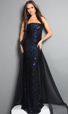 Woman in a strapless, floor-length Jovani 45306 black and blue formal dress adorned with dazzling sequins and featuring a sheer black cape overlay, standing against a plain gray background.