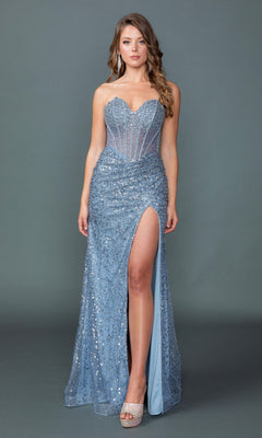 A woman models the Strapless Long Blue Prom Dress: Dancing Queen 4534, featuring a beaded corset-style bodice and high leg slit, while standing against a plain gray background.
