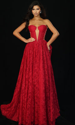 A woman models the Jovani 45372 long prom dress, featuring a strapless fitted corset bodice with sheer panels and a bold red floral lace design, set against a black background.