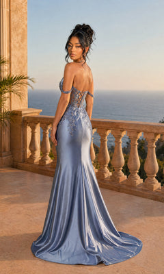 A woman wearing the Off-Shoulder Mermaid Prom Gown: Dancing Queen 4540, a fitted light blue satin dress with floral accents, stands on a stone balcony overlooking the ocean at sunset.