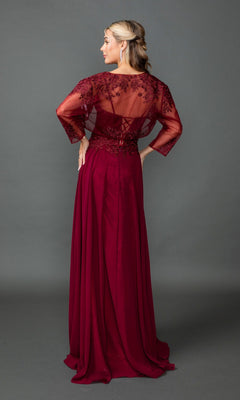 Woman wearing the Dancing Queen 4542 long prom dress in burgundy with lace embroidery on sheer sleeves and back, stands facing away against a plain gray background.